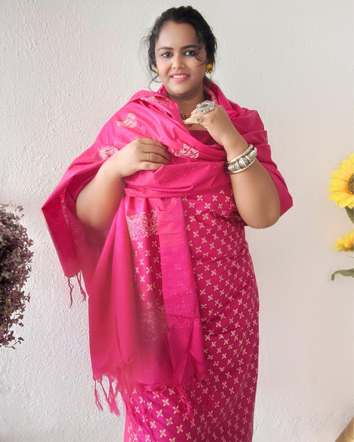 Vivid fuchsia pink katan silk unstitched suit set with a large hand block printed feather-like botanical motif on the dupatta
