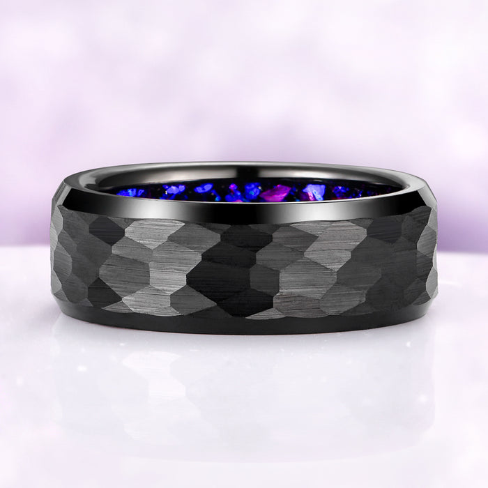 Black tungsten ring with blue and purple light on a white background
