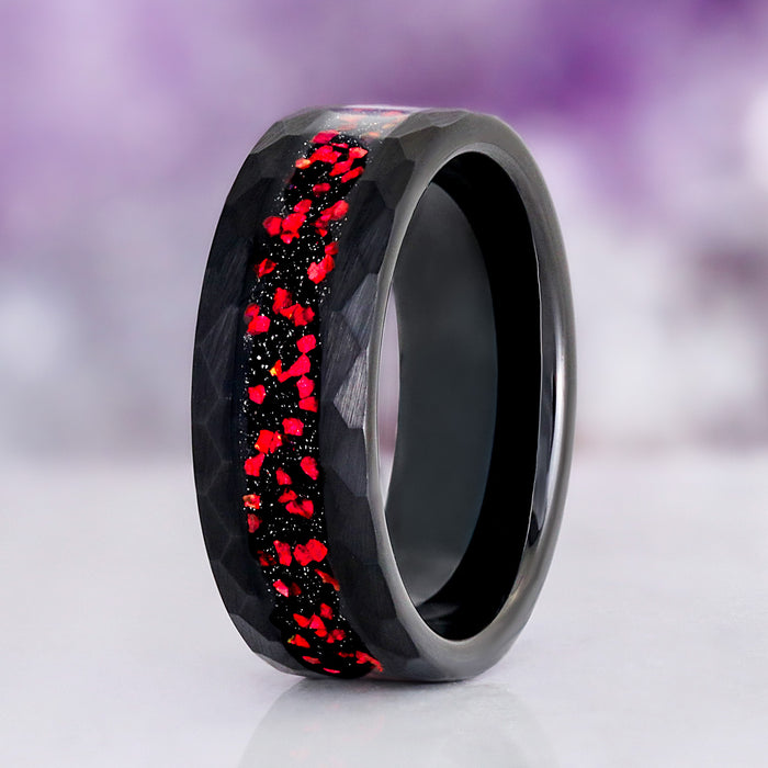 Galaxy Red Fire Opal Hammered Men's Ring in Black Tungsten Carbide (8mm) featuring crushed red fire opal and starry night blue sandstone inlay in a hammered black finish by Aquamarise.