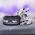Black Moissanite Leaf Ring Guard in 14K White Gold by Aquamarise Gold, showcasing a delicate vine and leaf motif accented with black moissanites alongside a complementary dark band with textured silver inlay, featured in Solid Gold Engagement Rings and Lovers of the Dark™ collections.