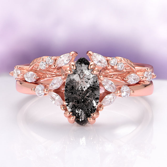 Galaxy Salt and Pepper (Herkimer) Diamond & Meteorite Couples Ring Set by Aquamarise, featuring a rose gold band with an oval salt and pepper diamond centerpiece surrounded by leaf-shaped white gemstones, blending celestial charm with romantic elegance.