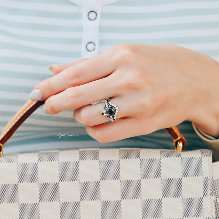 Hand adorned with the Galaxy Salt & Pepper (Herkimer) Diamond & Meteorite Couples Ring Set by Aquamarise, showcasing a striking coffin-cut diamond paired with a textured meteorite band, styled holding a checkered designer handbag.