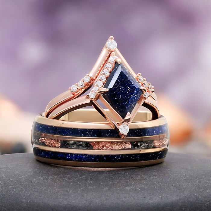 Galaxy Sandstone Couples Ring Set by Aquamarise, featuring a rose gold band with a sparkling blue sandstone center and complementary matching band with mixed metal and blue inlays.