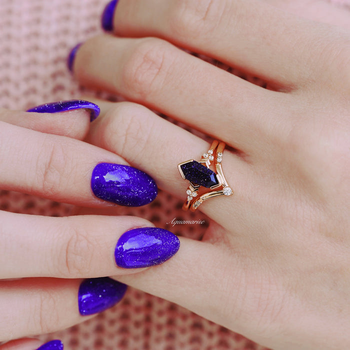 Galaxy Sandstone (Starry Night) Engagement Ring Set in 14K Solid Rose Gold by Aquamarise Gold, featuring a coffin cut deep blue sandstone and delicate diamond accents, styled with glittery purple nails.