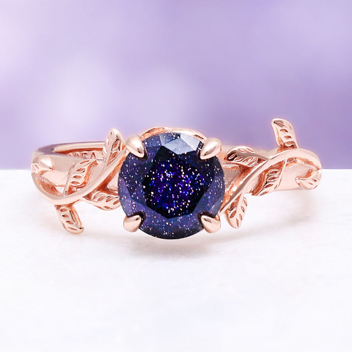 Galaxy sandstone leaf ring — round blue goldstone in a 14K rose gold vermeil leaf and vine setting