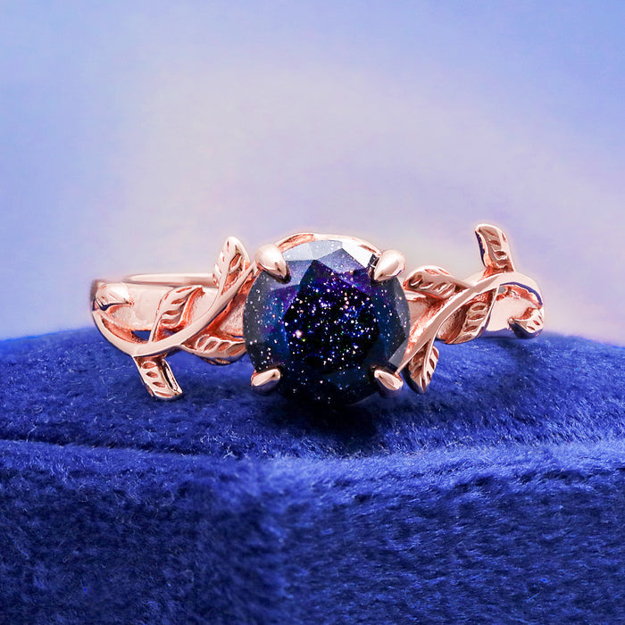 Angled view of the galaxy sandstone leaf ring, showing the sculpted rose gold vermeil leaves