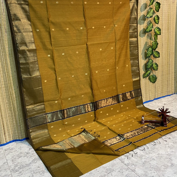 Golden mustard yellow Maheshwari silk saree with small gold buti and metallic borders edged in dark brown, handwoven in Maheshwar