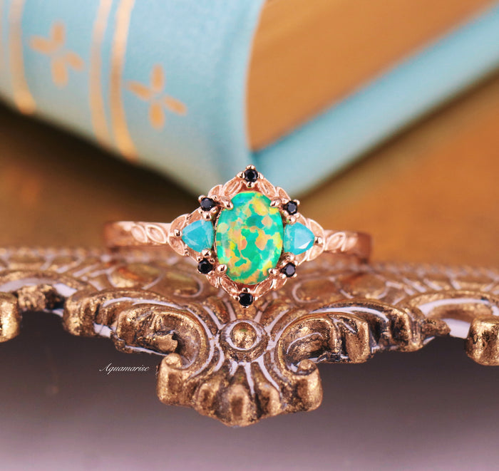 Green Fire Opal Leaf Engagement Ring in 14K Rose Gold Vermeil by Aquamarise featuring an opalescent green fire opal center with delicate black and aqua gemstone accents.