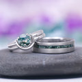 Green Moss Agate & Crescent Moon Couples Ring Set featuring a round moss agate stone cradled by a crescent moon-shaped sterling silver band alongside a matte silver band with an inlay of green moss agate, crafted by Aquamarise from Matching Couples' Rings and Moss Agate Jewelry collections.