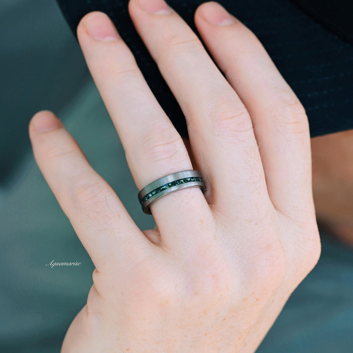 Green Moss Agate & Crescent Moon Couples Ring Set displayed on a hand, featuring a sleek band with a deep green moss agate inlay encased by matte silver and black metal edges, crafted by Aquamarise from Matching Couples' Rings and Moss Agate Jewelry collections.