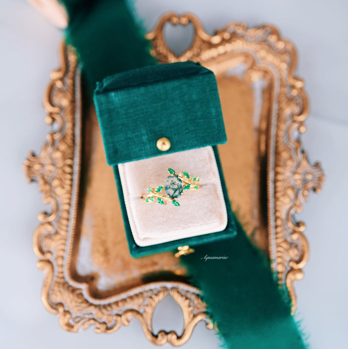 Green Moss Agate & Fire Opal & Gold Leaf Couples Ring Set displayed in green velvet box on ornate gold tray, showcasing nature-inspired design by Aquamarise with gemstone and leaf accents.