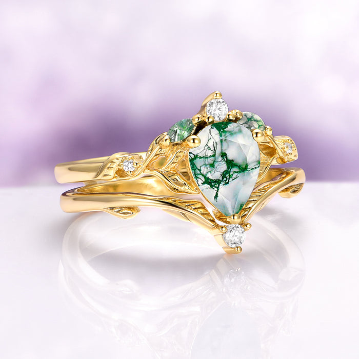 Green Moss Agate Leaf Engagement Ring Set in 14K Solid Yellow Gold featuring a pear-shaped green moss agate with intricate gold leaf and feather motifs accented by sparkling diamonds, part of Aquamarise Gold’s nature-inspired collection.