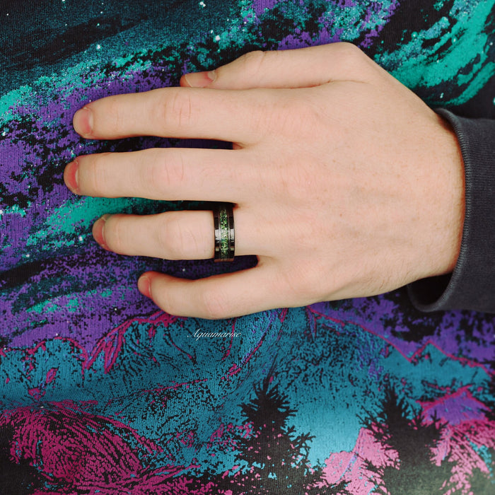 Green Moss Agate Wedding Band in Two Tone Black Tungsten Carbide (8mm) worn on hand, featuring crushed moss agate inlay with black tungsten carbide by Aquamarise.