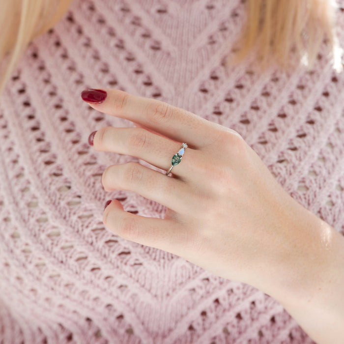 Green Moss Agate & Natural Australian Fire Opal Ring in Sterling Silver by Aquamarise worn on hand, featuring pear-shaped green moss agate with white fire opal and sparkling simulated diamond accent.