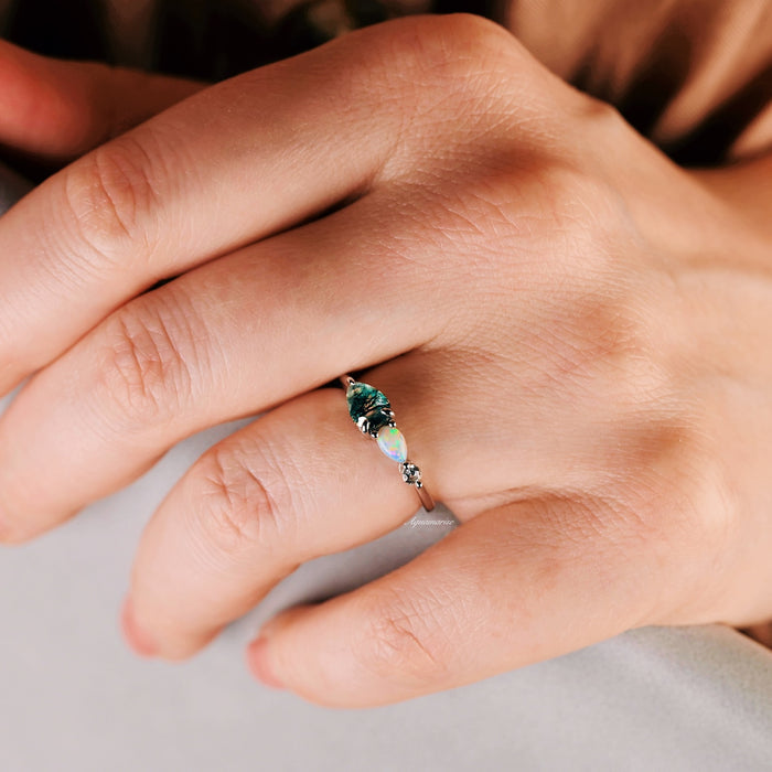 Green Moss Agate & Natural Australian Fire Opal Ring in Sterling Silver by Aquamarise, featuring a pear-shaped green moss agate and round white fire opal with CZ accents on a delicate band.