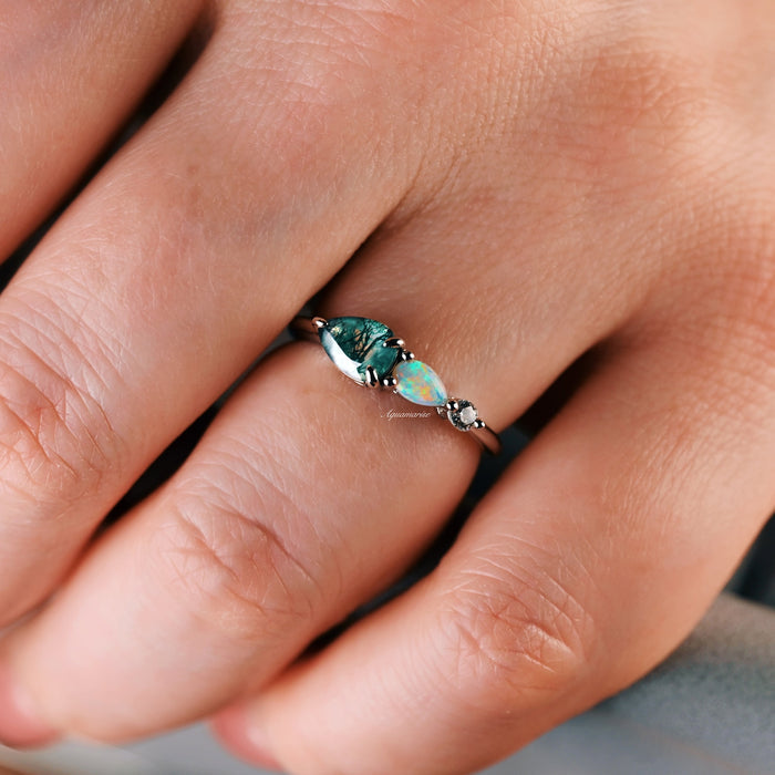Green Moss Agate & Natural Australian Fire Opal Ring in Sterling Silver by Aquamarise featuring pear-shaped moss agate, white fire opal, and CZ accent on a delicate band worn on hand.