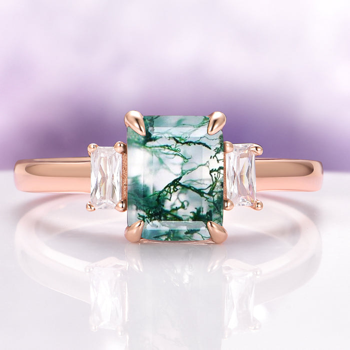 Green Moss Agate Ring in 14K Rose Gold Vermeil by Aquamarise featuring a rectangular moss agate center stone flanked by two clear baguette-cut gemstones on a polished rose gold band.