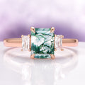 Green Moss Agate Ring in 14K Rose Gold Vermeil by Aquamarise featuring a rectangular moss agate center stone flanked by two clear baguette-cut gemstones on a polished rose gold band.