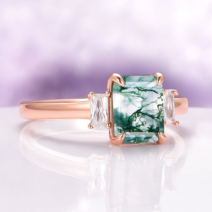 Green Moss Agate Ring in 14K Rose Gold Vermeil by Aquamarise featuring a three-stone design with a rectangular moss agate and baguette-cut side stones on a polished rose gold band.