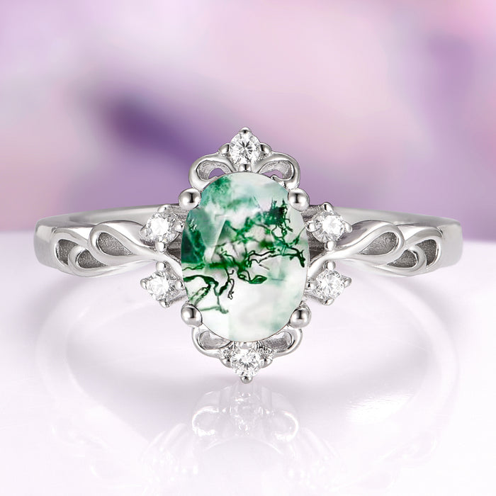 Green Moss Agate Woodland Twirl Engagement Ring in 14K White Gold by Aquamarise Gold, featuring an oval green moss agate center stone with natural forest-like inclusions, surrounded by delicate white diamonds on a nature-inspired twirl band, part of Solid Gold Engagement Rings and Non-Traditional Gemstone Engagement Rings collections.