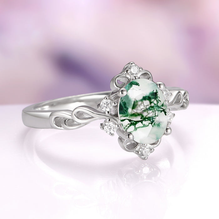 Green Moss Agate Woodland Twirl Engagement Ring in 14K White Gold by Aquamarise Gold, showcasing an oval green moss agate center stone with natural forest-like patterns, accented by delicate white diamonds on an intricately twirled solid gold band, part of Solid Gold Engagement Rings and Nature-Inspired Engagement Rings collections.