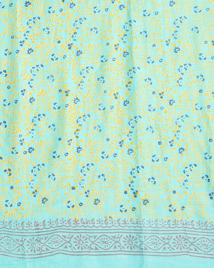 Ombre katan silk unstitched suit set shading from green and turquoise to peach and yellow, with hand block printed leaf vines and a tasselled dupatta