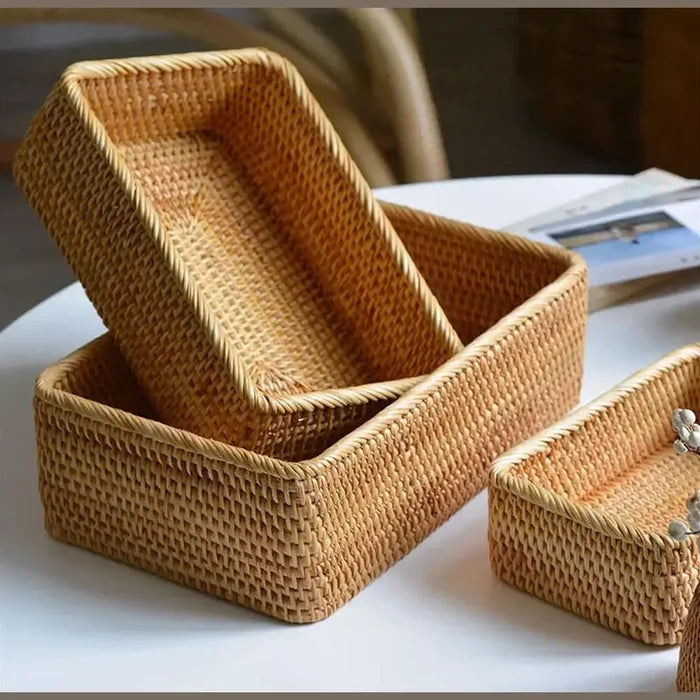 Handwoven rattan storage basket set with warm natural tones on a table, perfect for organizing any space.