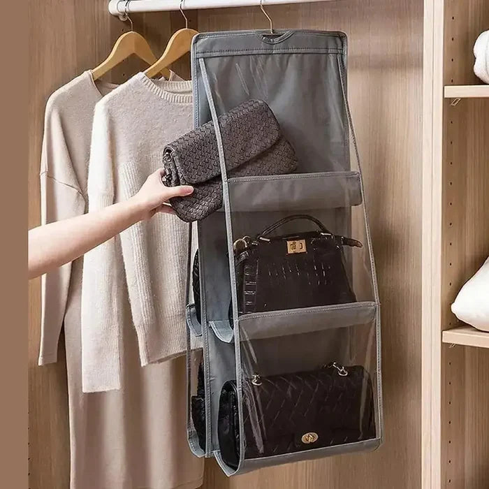 hanging handbag organizer displayed with bags in clear-view pockets and a grey foldable design for closet storage