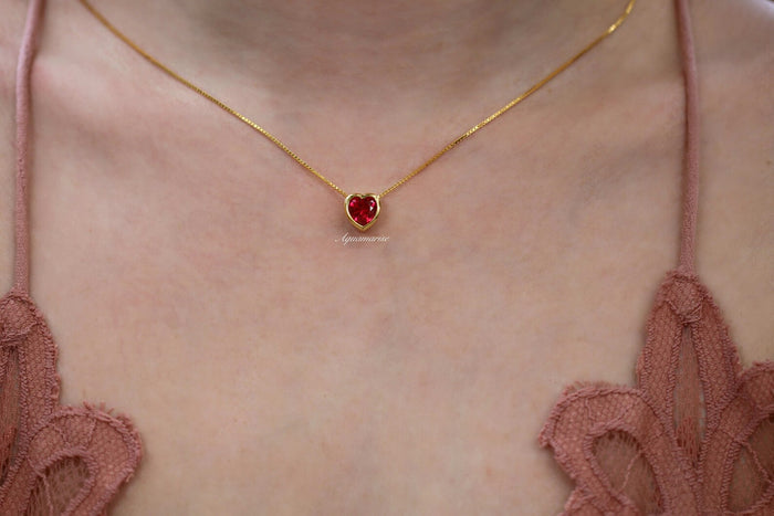 Heart Ruby Necklace in 14K Yellow Gold Vermeil by Aquamarise featuring a heart-shaped ruby pendant on a delicate yellow gold vermeil chain, styled as a minimalist and elegant piece from the July Birthstone Jewelry collection.