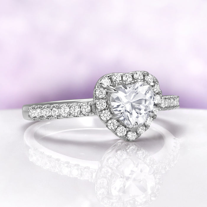 Heart White Sapphire Promise Ring in Sterling Silver by Aquamarise, showcasing a heart-shaped white sapphire surrounded by pavé diamonds on an elegant sterling silver band.