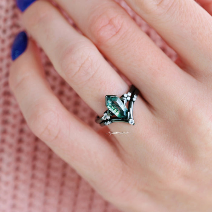 Hexagon Coffin Green Moss Agate Engagement Ring Set in Black Ruthenium by Aquamarise, showcasing a unique geometric green gemstone ring on a hand with navy blue nail polish.