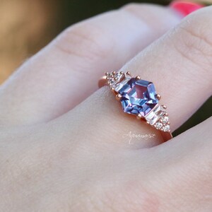Hexagon Cut Lab-Grown Alexandrite Ring in 14K Rose Gold Vermeil by Aquamarise, featuring a striking hexagonal lab-grown alexandrite center stone accented with sparkling side stones on a polished rose gold vermeil band, part of Rose Gold Vermeil Rings and June Birthstone Jewelry collections.