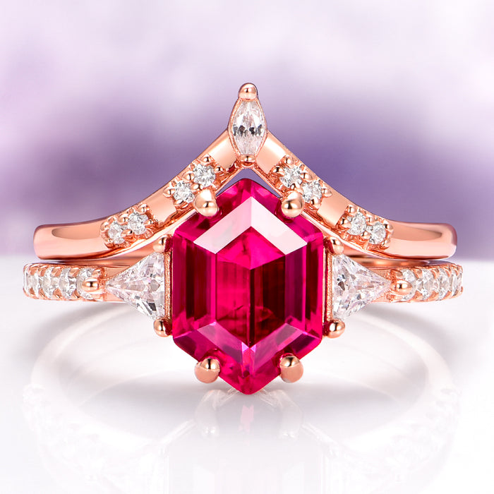 Hexagon Ruby Engagement Ring Set in 14K Solid Rose Gold by Aquamarise Gold, featuring a bold hexagon-cut ruby with diamond accents on elegantly curved rose gold bands.