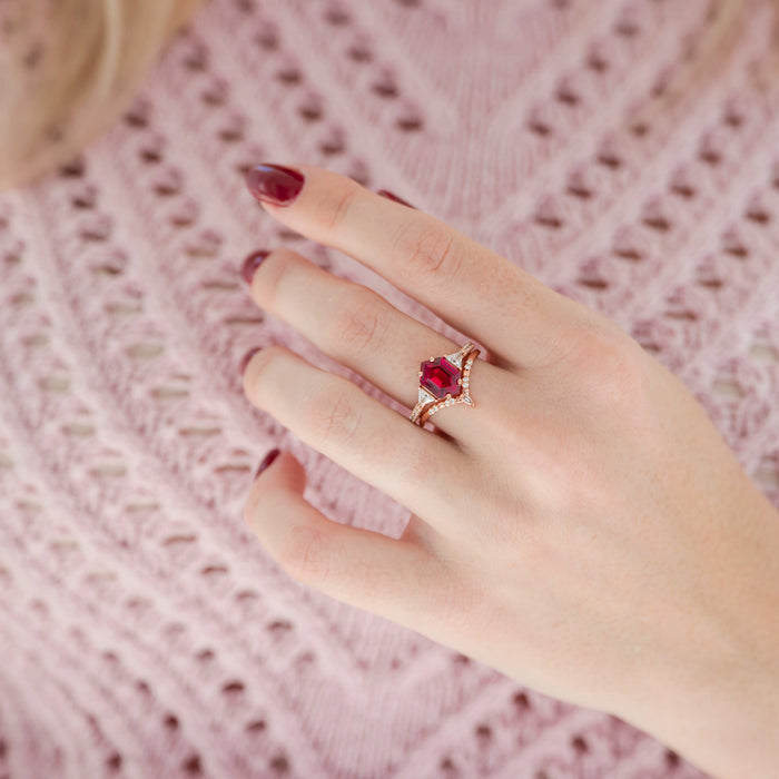 Hexagon Ruby Engagement Ring Set in 14K Solid Rose Gold, featuring a lab-grown ruby and delicate diamond details, styled on a hand with deep red nails and a textured pink sweater.