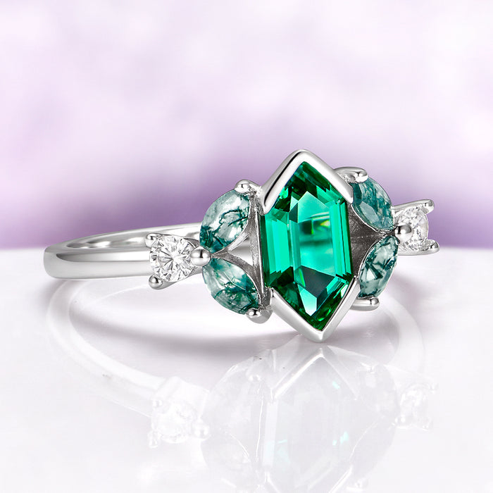 Hexagon Emerald & Moss Agate Leaf Engagement Ring in 14K White Gold by Aquamarise Gold, featuring a hexagonal emerald center with moss agate leaf accents and sparkling diamond details.