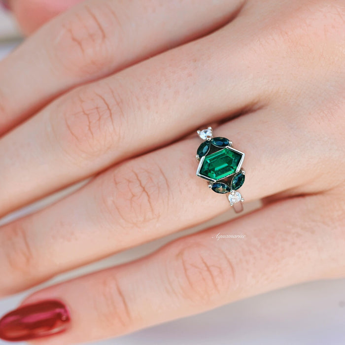 Hexagon Emerald & Moss Agate Leaf Ring- 14K White Gold with a hexagonal emerald centerpiece, blue-green moss agate accents, and delicate white stones set in a nature-inspired design by Aquamarise Gold.