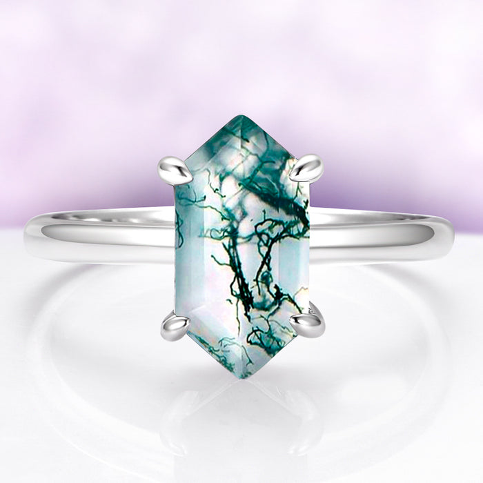 Ring with a green gemstone on a white background