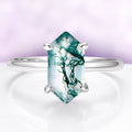 Ring with a green gemstone on a white background
