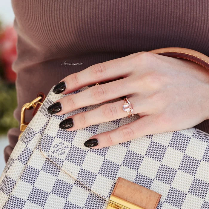 Hexagon Morganite Couples Ring Set by Aquamarise, featuring rose gold bands with a hexagon-cut morganite and delicate accent stones, displayed on a hand holding a patterned designer handbag.