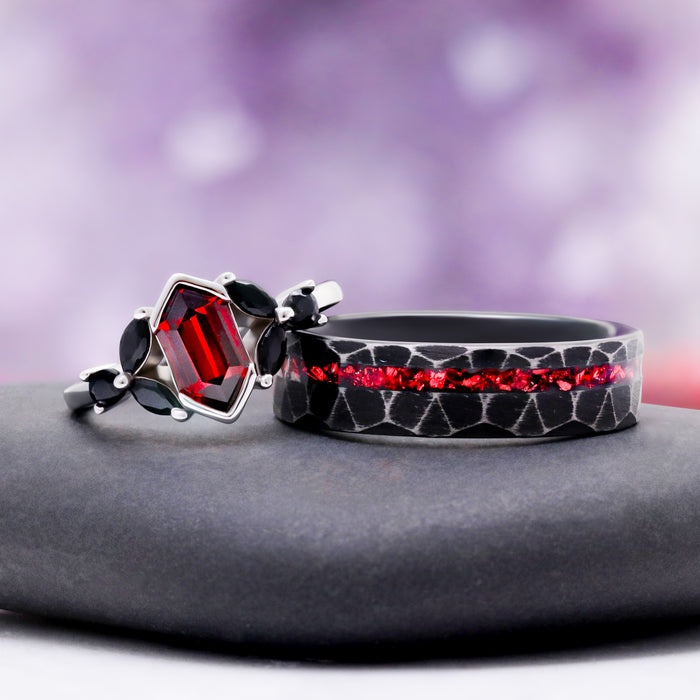 Red Dragon Garnet & Black Onyx Couples Ring Set by Aquamarise, pairing a hexagon-cut garnet ring with a hammered black band inlaid with crushed red stone.