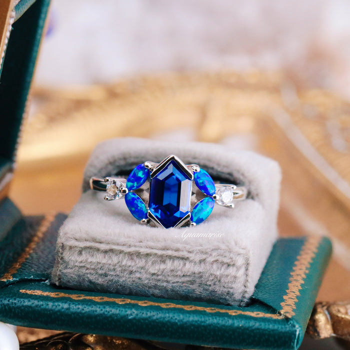 Blue Fire Opal & Sapphire Engagement Ring- Sterling Silver with a hexagonal sapphire center, marquise blue fire opals, and delicate accent stones in a silver setting by Aquamarise.