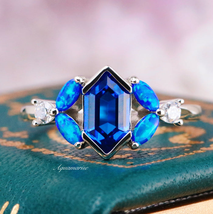 Blue Fire Opal & Sapphire Engagement Ring- Sterling Silver by Aquamarise featuring a geometric sapphire center, blue fire opals, and delicate accents in a fantasy-inspired design.