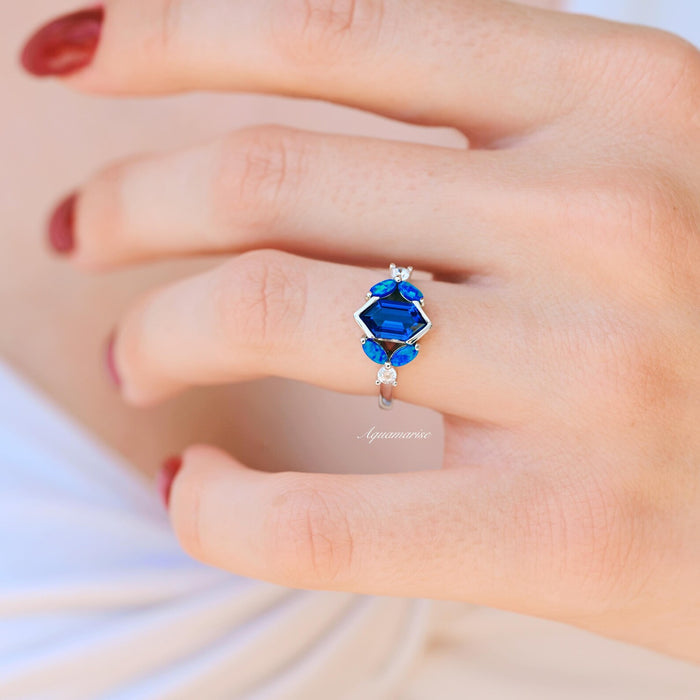 Blue Fire Opal & Sapphire Engagement Ring- Sterling Silver by Aquamarise, featuring a hexagonal deep blue sapphire with marquise fire opals and delicate accents in a fantasy-inspired setting.