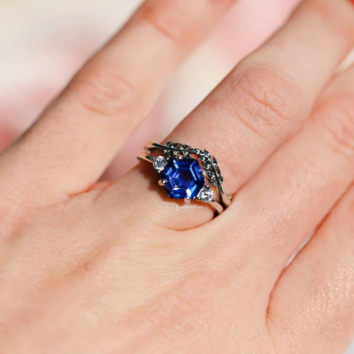 Hexagon Tanzanite Leaf Ring Set in Sterling Silver by Aquamarise featuring a deep blue hexagon-cut tanzanite accented with leaf-inspired bands and sparkling stones, part of Sterling Silver Rings collection.