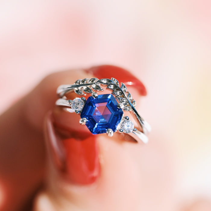 Hexagon Tanzanite Leaf Ring Set in Sterling Silver featuring a hexagon-cut deep blue tanzanite and leaf-inspired bands with sparkling side stones by Aquamarise.