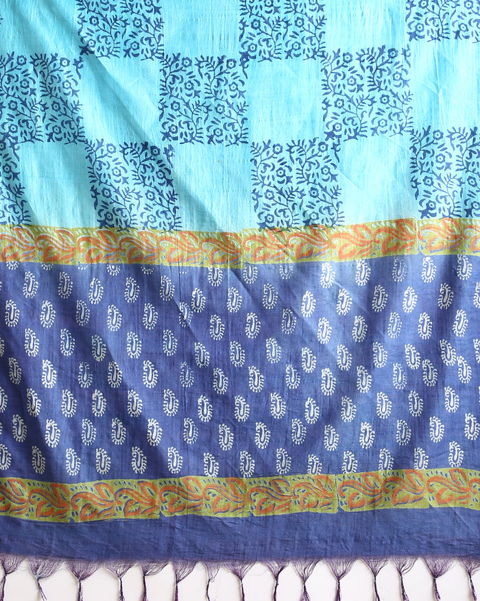 Indigo Katan silk unstitched suit set with all-over small paisley block print, pale blue decorative bands with yellow and green accents, and a fringed dupatta