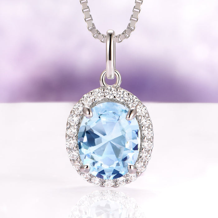 Iris Halo Oval Aquamarine Necklace in Sterling Silver featuring a 2.3 ct simulated aquamarine surrounded by a halo of sparkling simulated diamonds by Aquamarise.
