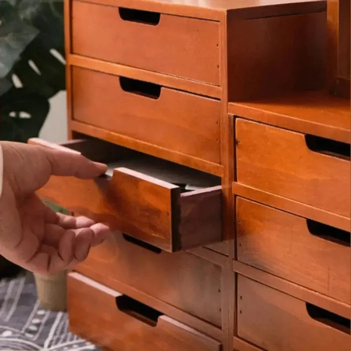 Japanese wooden desk organizer with a hand opening a drawer for easy access.
