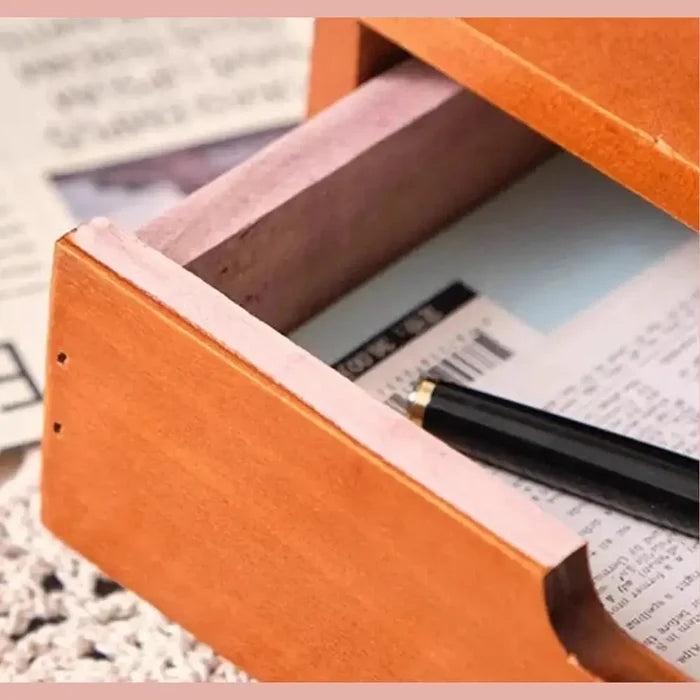 Close-up of a japanese wooden desk organizer drawer, showcasing neat storage for pens and papers.