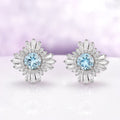 Joelle Art Deco Aquamarine Earrings in Sterling Silver by Aquamarise, featuring vintage-inspired round aquamarine centers surrounded by sparkling baguette and round accents.